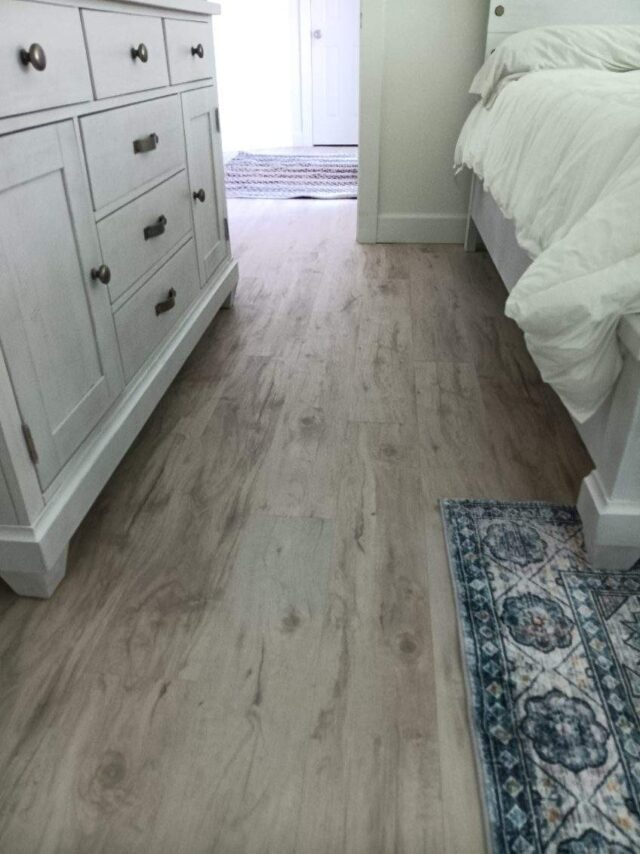 Clean bedroom with dresser and flooring
